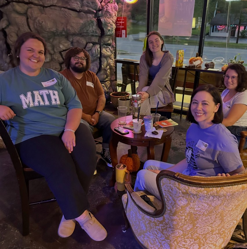 Emberlight Book Club members gathered around a table at Misty Ember Café